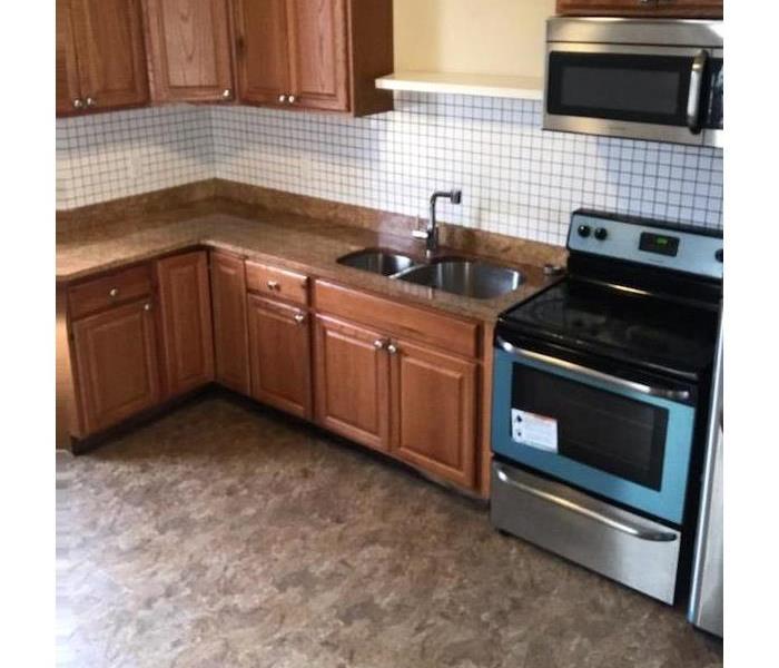 Clean kitchen with wooden cabinets and stainless steal appliances