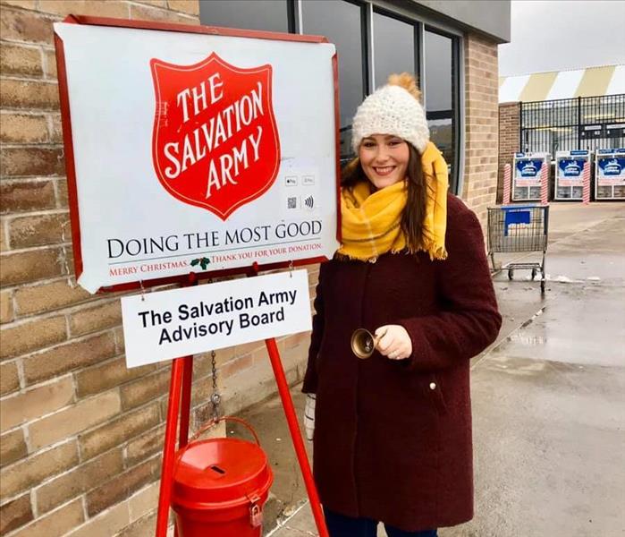 Woman ringing bell in front of Salvation Army Red Kettle and SignTaking some time the last two Wednesdays to volunteer