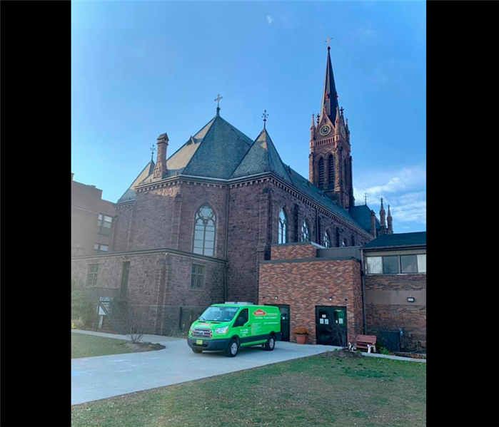 Green SERVPRO van in front of Church