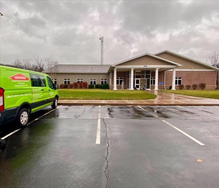 Green SERVPRO Truck outside of commercial building 