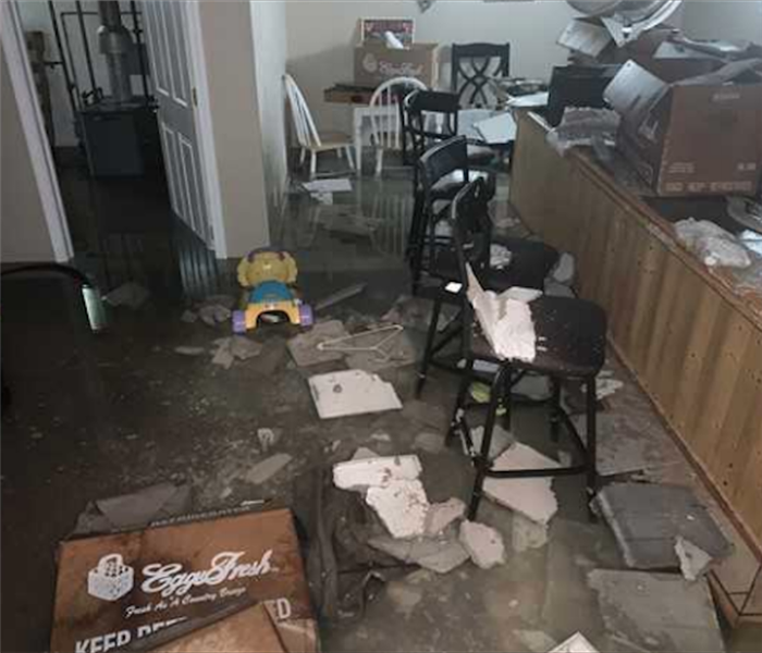 Ceiling tiles and debris on floor from water damage 
