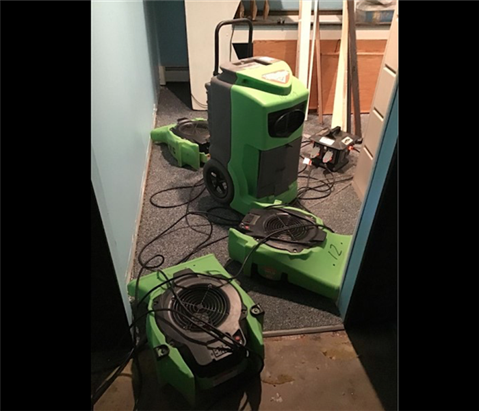 SERVPRO green dehumidifiers and air movers in residential home