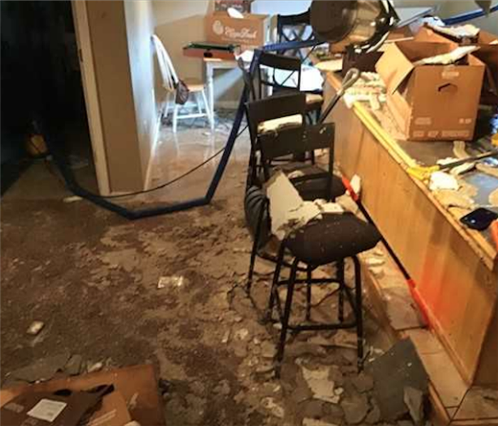 Water and debris on floor following water damage