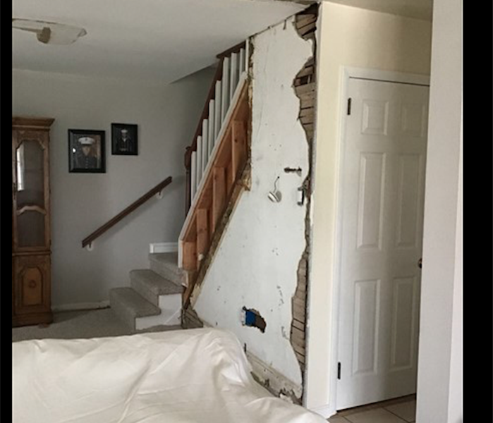 white wall near staircase with water damage 