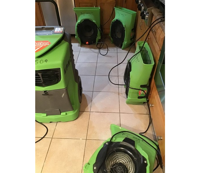 green SERVPRO equipment in kitchen of residential home